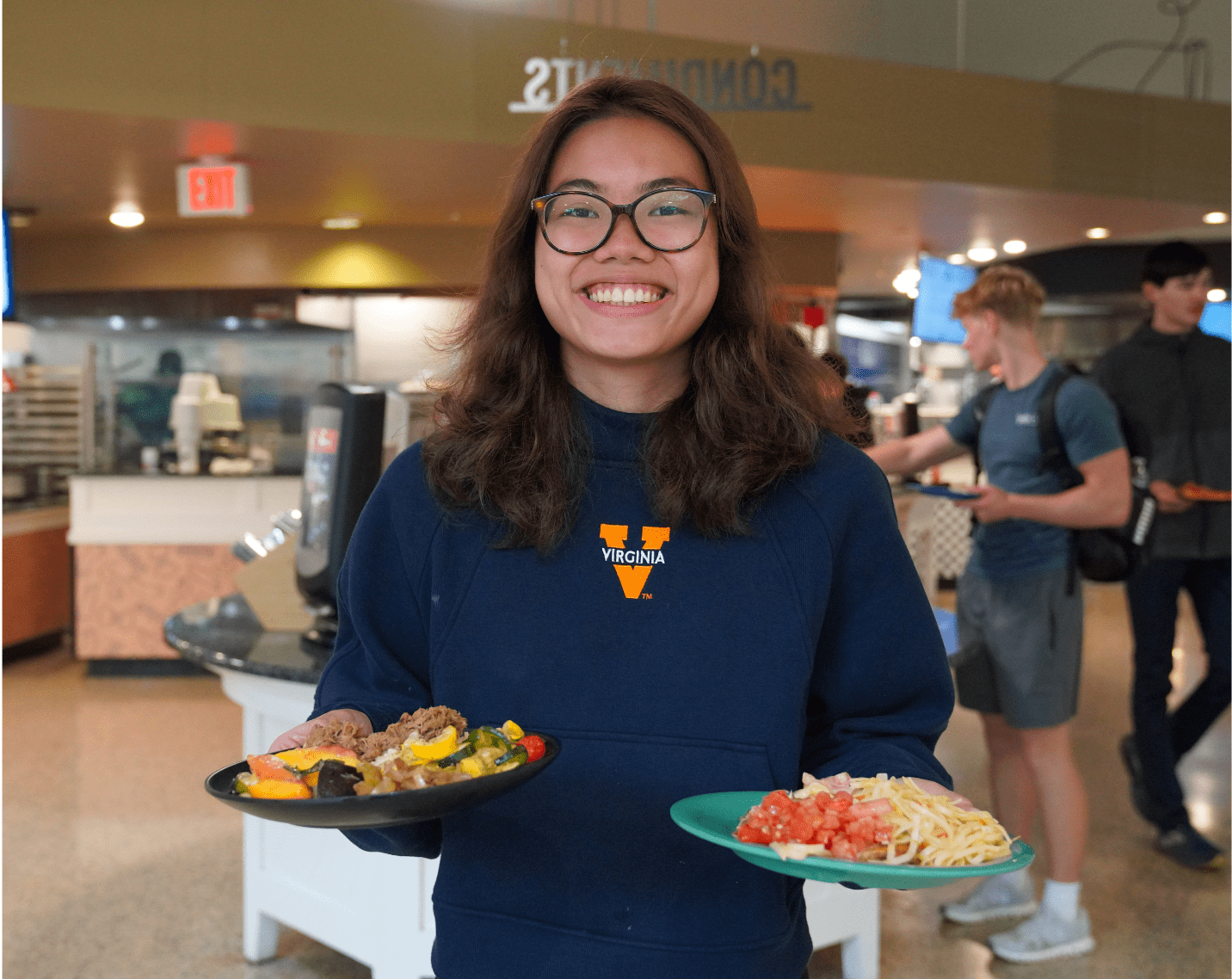 A student with a plate of food at the UVA Dine Farm to Fork event.